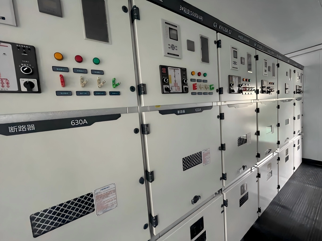 Close-up of KYN28A-12 switchgear facades showing relay protection devices and 630A circuit breaker compartments