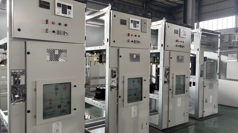 Metal enclosed switchgear cabinets with open doors showing internal busbars and circuit breakers during assembly