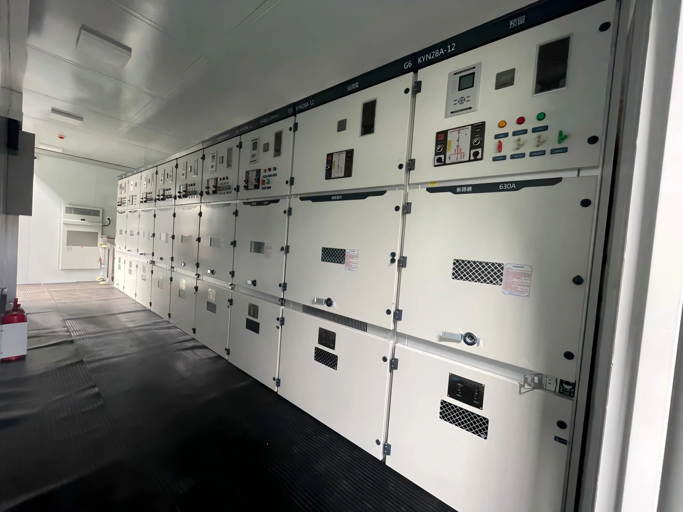 Row of KYN28A-12 medium voltage switchgear panels installed inside a prefabricated substation container