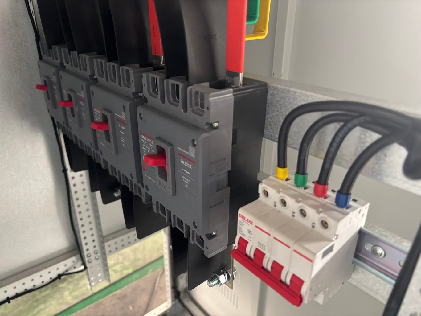 Row of molded case circuit breakers and MCBs mounted on LV switchgear busbar