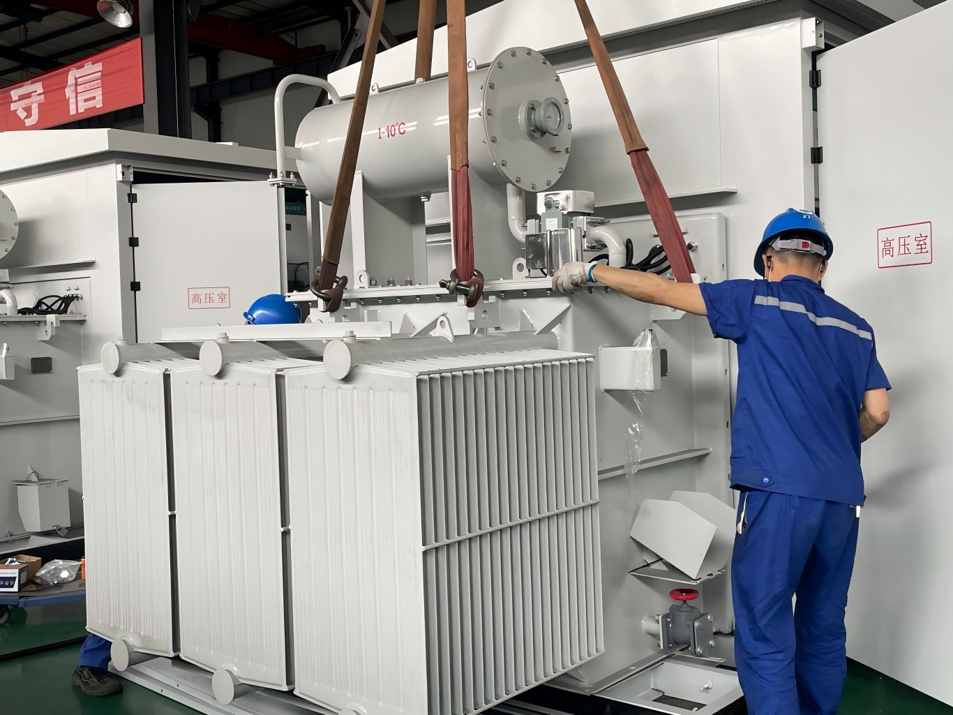 Lifting prefabricated box substation transformer with sling in workshop