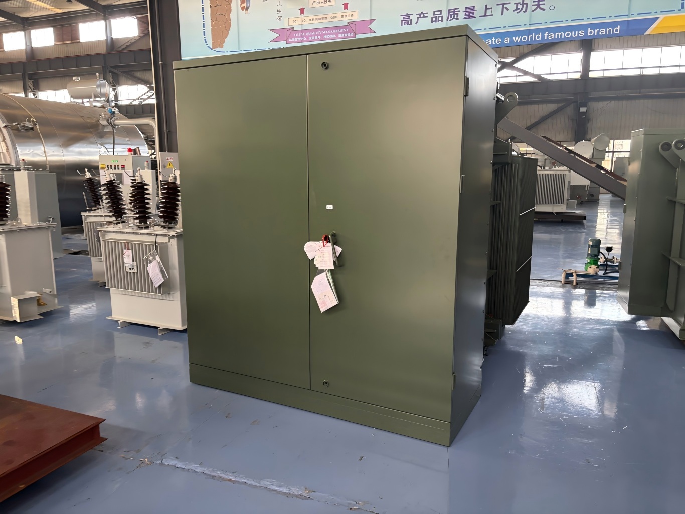 Pad-mounted box type transformer unit in factory workshop