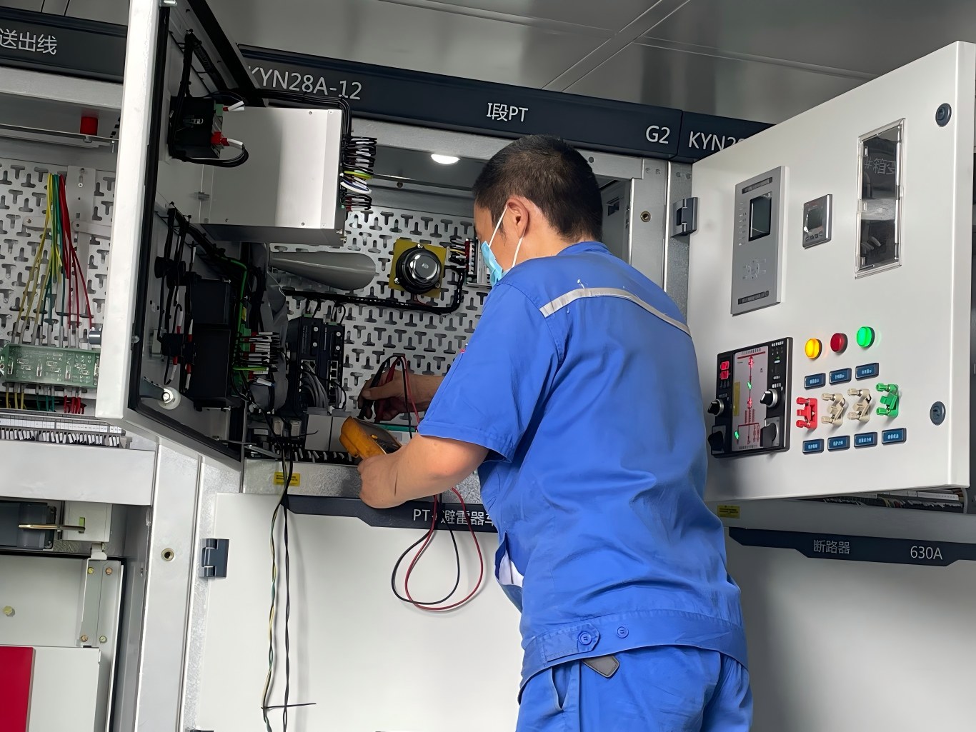 Worker testing KYN28A-12 high voltage switchgear in the containerized substation