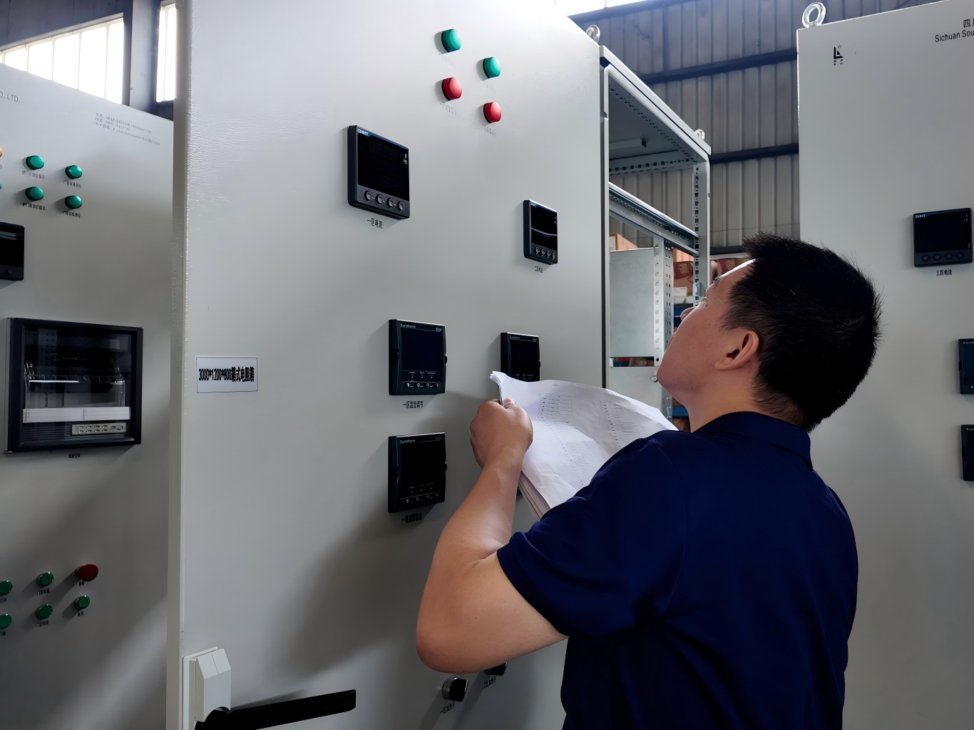 Engineers checking drawings for electric resistance furnace temperature control cabinet